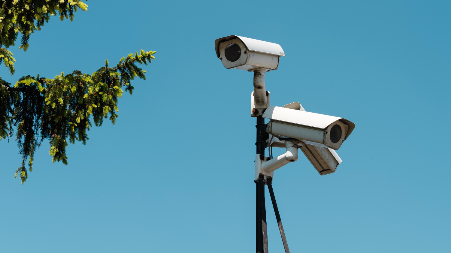 two CCTV cameras on a pole